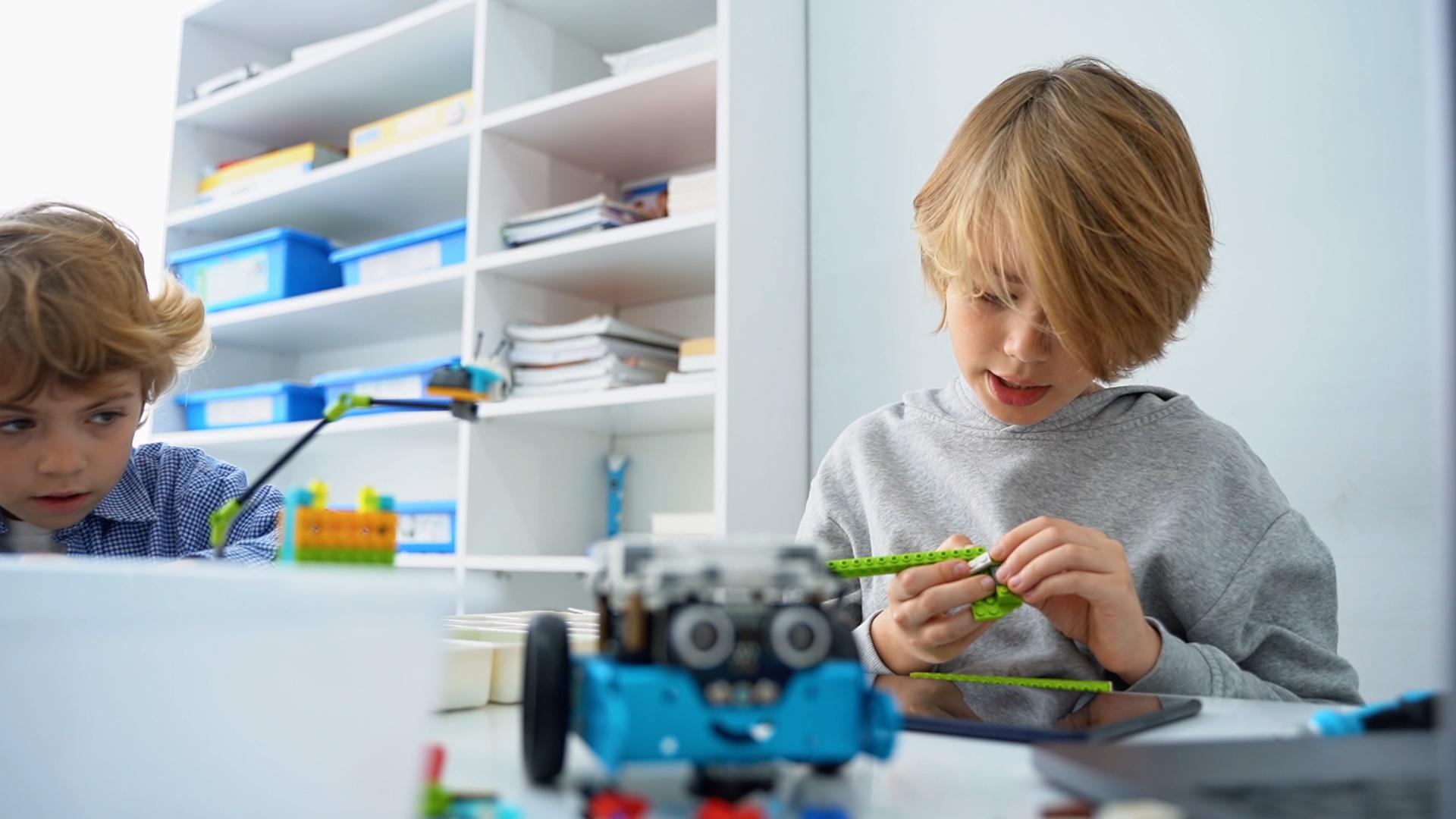Students participating in a multimedia educational workshop with interactive screens and digital content